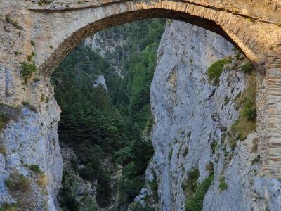 Ancient stone bridge over a picturesque gorge in Leuk, Switzerland, showcasing natural beauty and historic architecture.