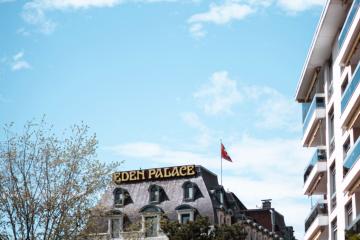 Elegant Eden Palace Hotel captured in Montreux, Switzerland with clear blue skies.