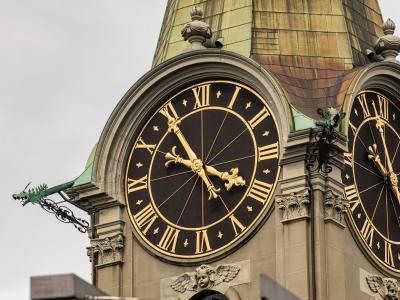 Close-up of a historic clock tower with Roman numerals in Bern, Switzerland.