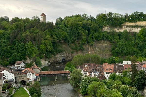 Explore the medieval charm of Fribourg, Switzerland, overlooking the scenic Saane River and historic buildings.
