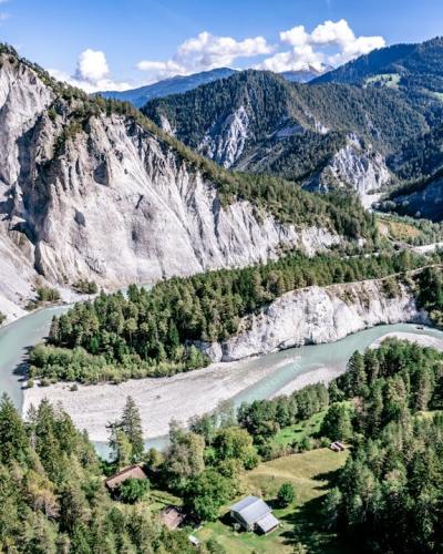 a river running through a valley between mountains