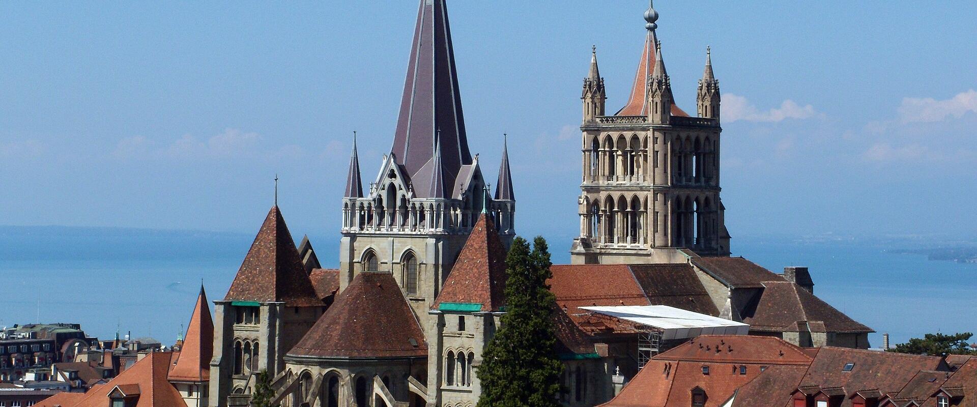 Lausanne Cathedral above the old town roofs, with Lake Geneva beyond