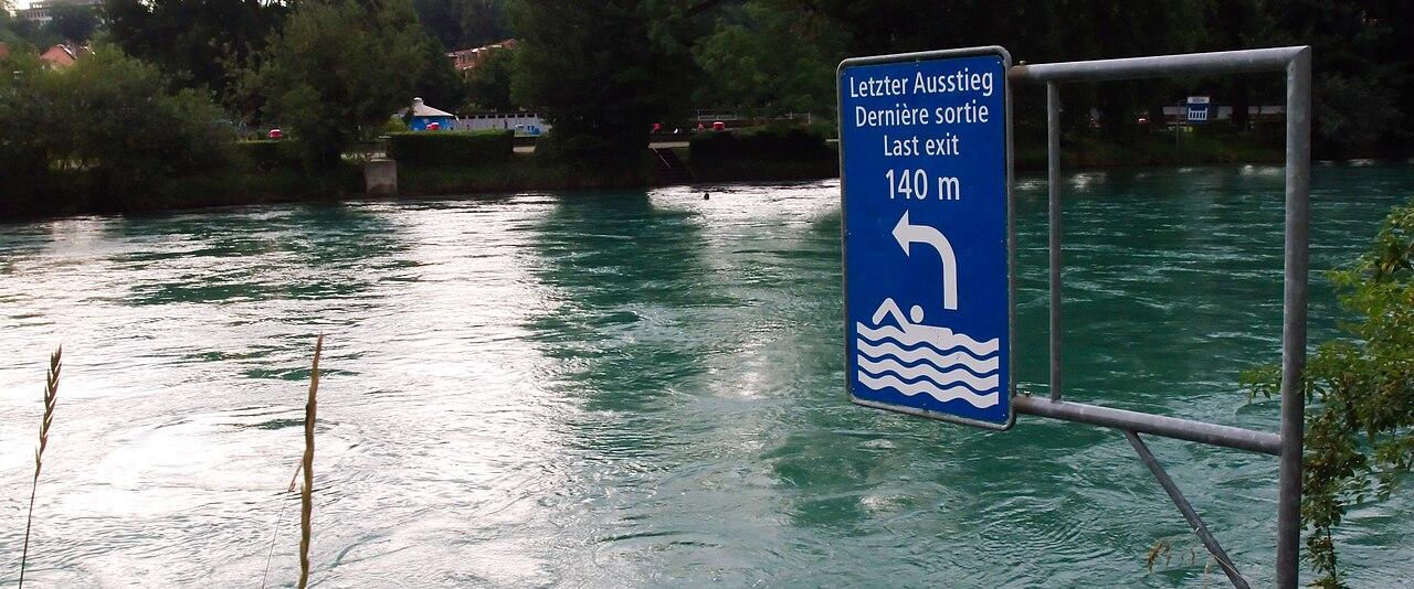 The Aare at the Marzili in Bern, with a 'last exit' sign marking the final place to leave the river