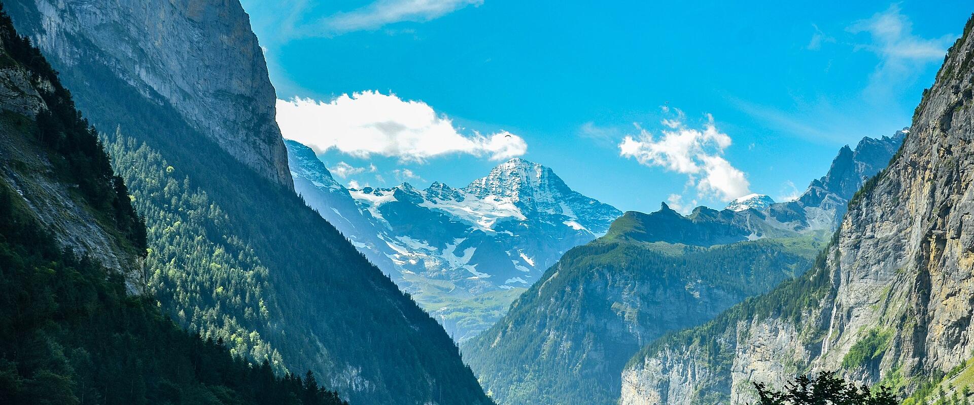 The Lauterbrunnen Valley floor between sheer cliffs, with snowy peaks at its head