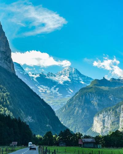 The Lauterbrunnen Valley floor between sheer cliffs, with snowy peaks at its head
