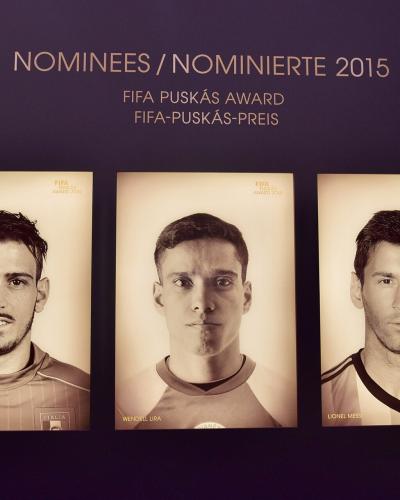 A display wall inside a museum featuring framed portraits of three football players (Alessandro Florenzi, Wendell Lira, Lionel Messi) nominated for the 2015 FIFA Puskás Award, with bilingual signage in English and German ("NOMINEES / NOMINIERTE 20