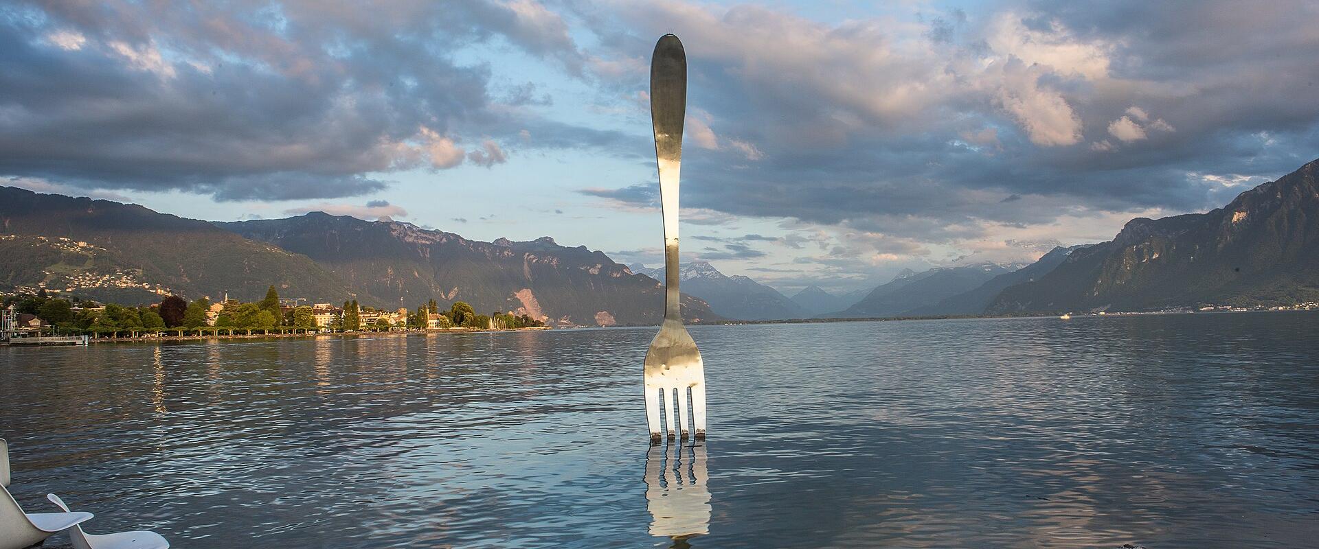 The giant fork sculpture in Lake Geneva at Vevey at sunset