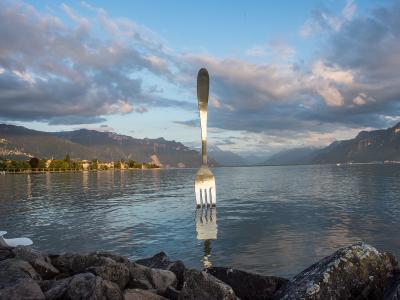 The giant fork sculpture in Lake Geneva at Vevey at sunset