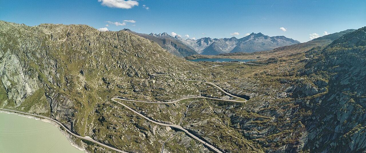 The Grimsel Pass road winding through rocky mountains above a reservoir