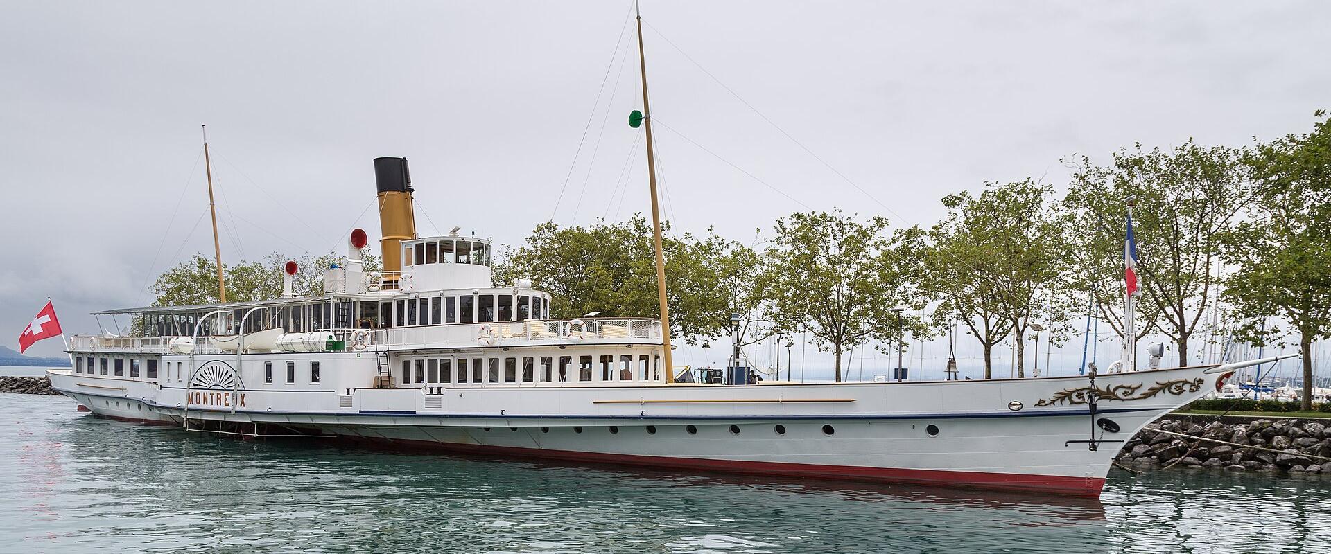 Paddle steamer Montreux moored at the tree-lined quay of Ouchy