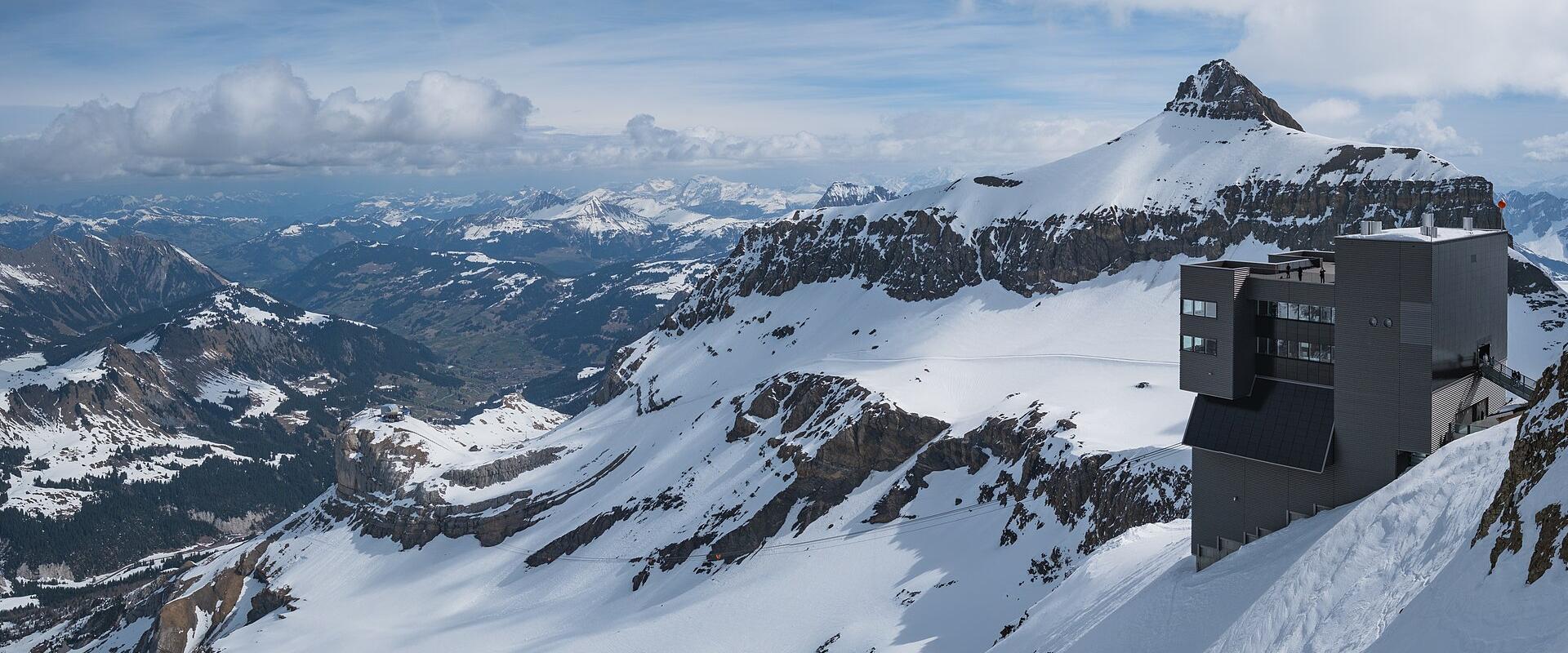 The Scex Rouge cable-car station of Glacier 3000 above snowfields and peaks of the Diablerets massif