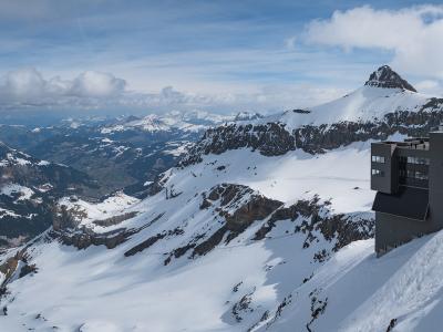 The Scex Rouge cable-car station of Glacier 3000 above snowfields and peaks of the Diablerets massif