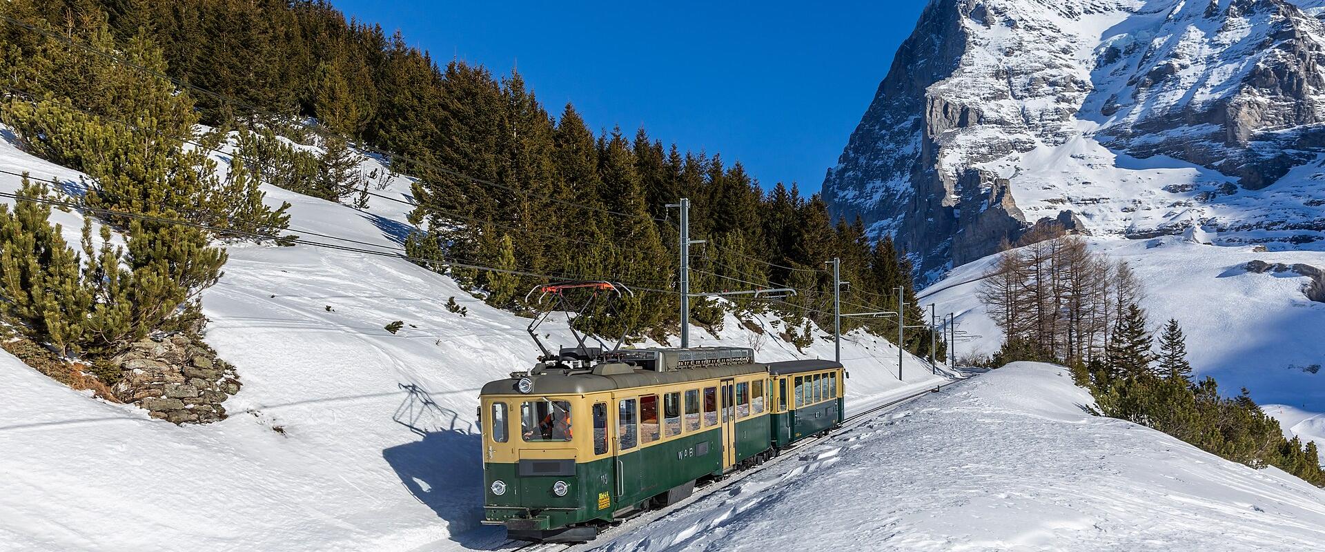 A Wengernalp Railway train climbing through snow to Kleine Scheidegg below the Eiger