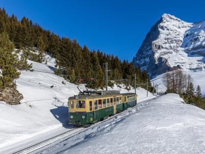 A Wengernalp Railway train climbing through snow to Kleine Scheidegg below the Eiger