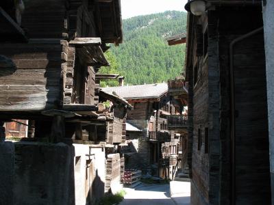 Old wooden larch barns and houses lining a lane in Zermatt's Hinterdorf