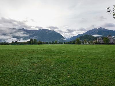 The open Höhematte meadow in central Interlaken with mountains behind