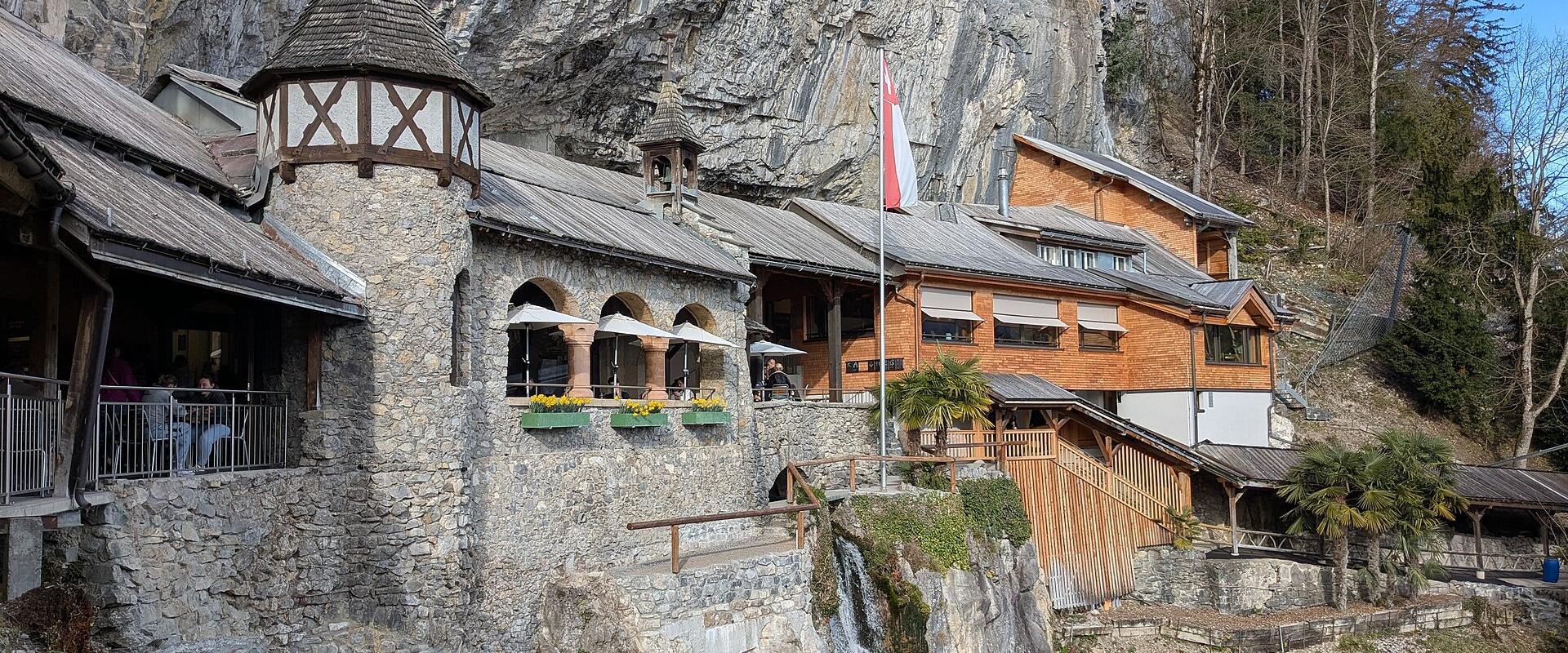 The entrance buildings of the St. Beatus Caves set into the cliff above Lake Thun