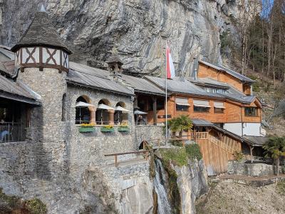 The entrance buildings of the St. Beatus Caves set into the cliff above Lake Thun