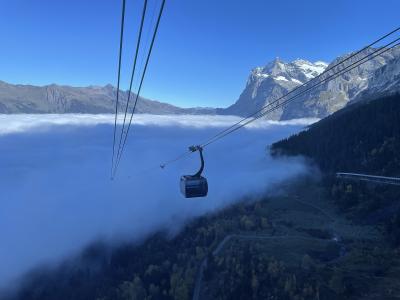 An Eiger Express gondola cabin above a sea of cloud near Grindelwald