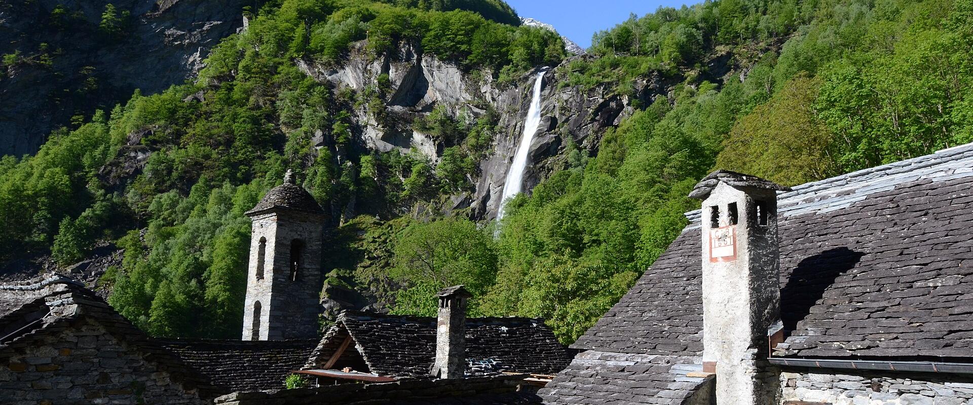 Stone-roofed houses of Foroglio below its waterfall, Val Bavona