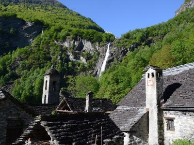 Stone-roofed houses of Foroglio below its waterfall, Val Bavona