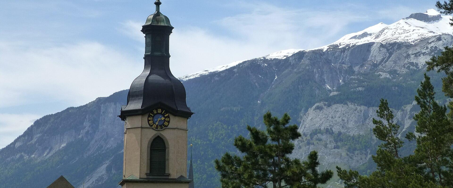 The tower of Chur Cathedral against the mountains