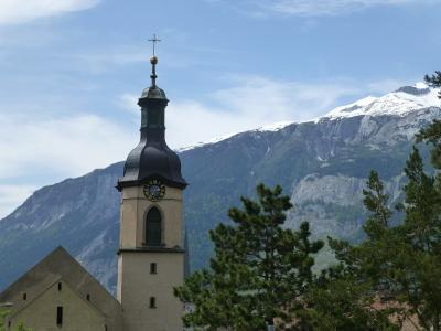 The tower of Chur Cathedral against the mountains