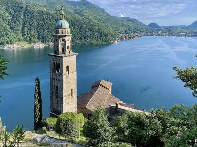 The bell tower of Santa Maria del Sasso above Morcote and Lake Lugano