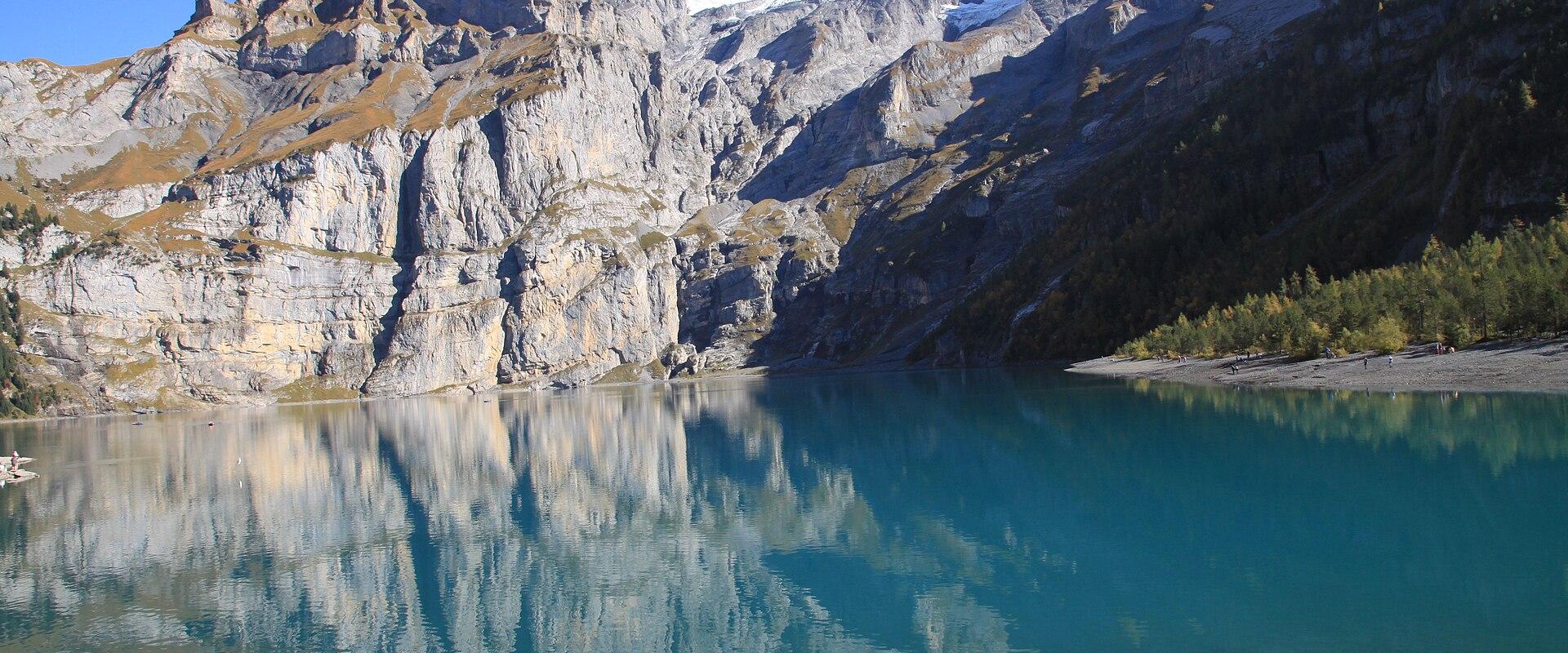 Turquoise Oeschinensee reflecting the cliffs above Kandersteg