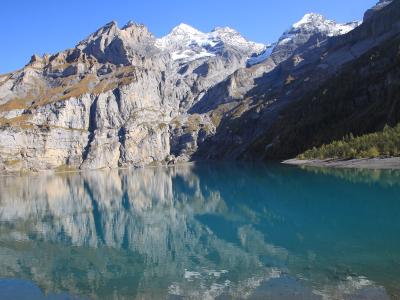 Turquoise Oeschinensee reflecting the cliffs above Kandersteg